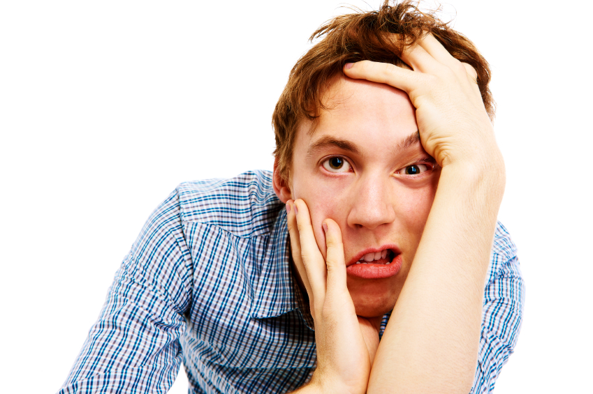 young man pulling funny face on white background